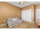 Bedroom with neutral carpet, tan walls, a futon on the floor, closet, and a ceiling fan at 1209 Peyton Ct., Myrtle Beach, SC 29588