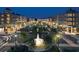 Night view of a city street featuring a lit fountain, restaurants, apartments, and retail shops at 1209 Peyton Ct., Myrtle Beach, SC 29588
