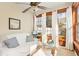 Bright sun room with white sofa, wood windows, ceiling fan, and charming decor at 1209 Peyton Ct., Myrtle Beach, SC 29588