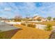 Spacious backyard with a view of a lake and neighboring homes at 1325 Cascarilla Ct., Myrtle Beach, SC 29579