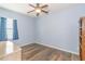 Light and airy bedroom with wood-look floors, ceiling fan, and built-in shelving at 1325 Cascarilla Ct., Myrtle Beach, SC 29579