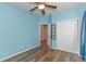 Bedroom with light blue walls, wood flooring, and double closet doors at 1325 Cascarilla Ct., Myrtle Beach, SC 29579