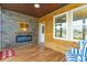 Relaxing sunroom with electric fireplace, wood walls, and plenty of natural light at 1325 Cascarilla Ct., Myrtle Beach, SC 29579