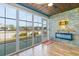 Cozy sunroom with electric fireplace, tile floors, and a view of the backyard at 1325 Cascarilla Ct., Myrtle Beach, SC 29579