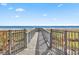 Wooden boardwalk path to beach with metal gates at 2001 S Ocean Blvd. # 1401, Myrtle Beach, SC 29577