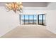 Living room with ocean view and chandelier at 2013 S Ocean Blvd. # 3D, North Myrtle Beach, SC 29582