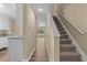 Hallway view showcasing stairs and kitchen leading to a naturally lit living area at 207 Townes Ct., Myrtle Beach, SC 29588