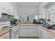 Functional kitchen with white cabinets and appliances and tile floors at 207 Townes Ct., Myrtle Beach, SC 29588