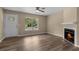 Comfortable living room with a fireplace and natural light from the large window at 207 Townes Ct., Myrtle Beach, SC 29588