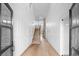 Elegant hallway with hardwood floors and modern staircase at 215 82Nd Ave. N, Myrtle Beach, SC 29572