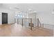 Light-filled hallway with hardwood floors and modern railing at 215 82Nd Ave. N, Myrtle Beach, SC 29572
