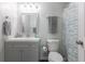 Well-lit bathroom features a gray vanity, silver framed mirror, and a toilet with a stylish shower curtain at 2268 Essex Dr. # L, Surfside Beach, SC 29575