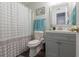 Bright bathroom with vanity sink, a decorated mirror, toilet, and shower with patterned curtain at 2268 Essex Dr. # L, Surfside Beach, SC 29575