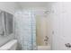 Cozy bathroom featuring a shower and tub combo with a patterned curtain, a towel, and a toilet at 2268 Essex Dr. # L, Surfside Beach, SC 29575