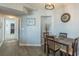 A casual dining area features a wood table with four chairs, attractive flooring, and a wall clock at 2268 Essex Dr. # L, Surfside Beach, SC 29575