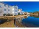 View of condo community with serene pond and manicured landscaping on a bright, sunny day at 2268 Essex Dr. # L, Surfside Beach, SC 29575