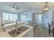 Spacious kitchen open to living and dining areas, with stainless steel sink and breakfast bar at 2268 Essex Dr. # L, Surfside Beach, SC 29575