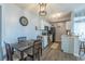 Cozy eat-in kitchen with white cabinets, black appliances, stylish light fixtures, and wood-look flooring at 2268 Essex Dr. # L, Surfside Beach, SC 29575