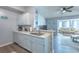 Bright, open kitchen features white cabinets, a breakfast bar, and views into the living room at 2268 Essex Dr. # L, Surfside Beach, SC 29575
