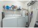 Functional laundry room features a washer, dryer, and water heater with storage shelves for organization at 2268 Essex Dr. # L, Surfside Beach, SC 29575