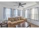 Cozy living room features a ceiling fan and multiple windows for ample natural light at 2268 Essex Dr. # L, Surfside Beach, SC 29575