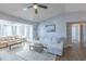 Inviting living room featuring a plush sectional sofa, ceiling fan, and hardwood flooring at 2268 Essex Dr. # L, Surfside Beach, SC 29575