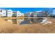 Scenic view of condo buildings reflected in a tranquil pond surrounded by well-maintained landscaping at 2268 Essex Dr. # L, Surfside Beach, SC 29575