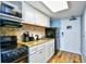 Small condo kitchen with granite countertop, white cabinets, and appliances at 2401 S Ocean Blvd. # 1160, Myrtle Beach, SC 29577