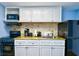 Small condo kitchen with granite countertop, white cabinets, and appliances at 2401 S Ocean Blvd. # 1160, Myrtle Beach, SC 29577