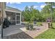 Relaxing screened porch and paver patio area with brick retaining wall and manicured yard in a beautiful outdoor living space at 2450 Craven Dr., Myrtle Beach, SC 29579