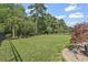 Large backyard is surrounded by lush landscaping and an elegant wrought iron fence for added privacy at 2450 Craven Dr., Myrtle Beach, SC 29579
