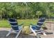 Serene backyard patio with Adirondack chairs and lush landscaping, perfect for outdoor relaxation and entertaining at 2450 Craven Dr., Myrtle Beach, SC 29579