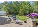 Charming backyard patio with Adirondack chairs, a well-manicured lawn, and beautiful flower accents in a peaceful setting at 2450 Craven Dr., Myrtle Beach, SC 29579