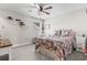 Inviting bedroom with a colorful floral bedspread, ceiling fan, and a cozy seating area near the window at 2450 Craven Dr., Myrtle Beach, SC 29579