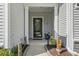 Covered front porch with decorative plants and tasteful accents provides a welcoming entrance at 2450 Craven Dr., Myrtle Beach, SC 29579