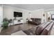 Comfortable living room features hardwood floors, a brown leather sofa, and a wall-mounted television at 2450 Craven Dr., Myrtle Beach, SC 29579