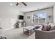 Living room with a large window, ceiling fan, gray sofa, and white coffee table at 2450 Craven Dr., Myrtle Beach, SC 29579