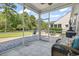 Relaxing screened porch with comfortable seating, a view of the landscaped backyard, and an outdoor grill area at 2450 Craven Dr., Myrtle Beach, SC 29579
