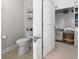 Toilet room featuring a toilet, towel rack, and open doorway to a closet with shelving at 2450 Craven Dr., Myrtle Beach, SC 29579