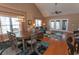 Bright dining room with a round table and six chairs, hardwood floors, and large windows at 249 Moonglow Circle # 201, Murrells Inlet, SC 29576