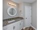 Updated bathroom features a vanity with granite countertop, a large mirror, and updated fixtures at 2623 Corn Pile Rd., Myrtle Beach, SC 29588