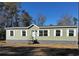 Single-story home with light green vinyl siding and stone accents at 2711 W Highway 9 Bypass, Loris, SC 29569