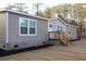 Tan mobile home with wood deck and landscaping at 2901 N Nichols Hwy., Nichols, SC 29581