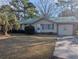 Ranch style home with green metal roof and attached garage at 334 Lincolnshire Dr., Georgetown, SC 29440