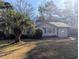 Beige house with green roof, palm tree, and yard at 334 Lincolnshire Dr., Georgetown, SC 29440