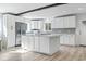 Kitchen features a central island, stainless steel appliances, white cabinets, hardwood flooring and recessed lighting at 3545 Marion Ln., Murrells Inlet, SC 29576