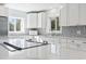Kitchen features a central island with stainless steel appliances, quartz counters and a subway tile backsplash at 3545 Marion Ln., Murrells Inlet, SC 29576