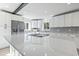 Island kitchen features stainless steel appliances, quartz countertop, white cabinets and recessed lights at 3545 Marion Ln., Murrells Inlet, SC 29576