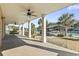 Covered patio with ceiling fans overlooking a serene waterfront view with boat dock at 3545 Marion Ln., Murrells Inlet, SC 29576