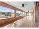 Spacious sunroom featuring wood paneled walls, hardwood flooring, and lots of natural light at 3545 Marion Ln., Murrells Inlet, SC 29576